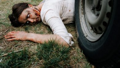 zombie lying underneath a car